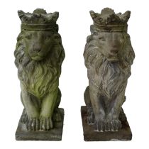 A pair of reconstituted stone lions - seated and wearing crowns, 36cm high