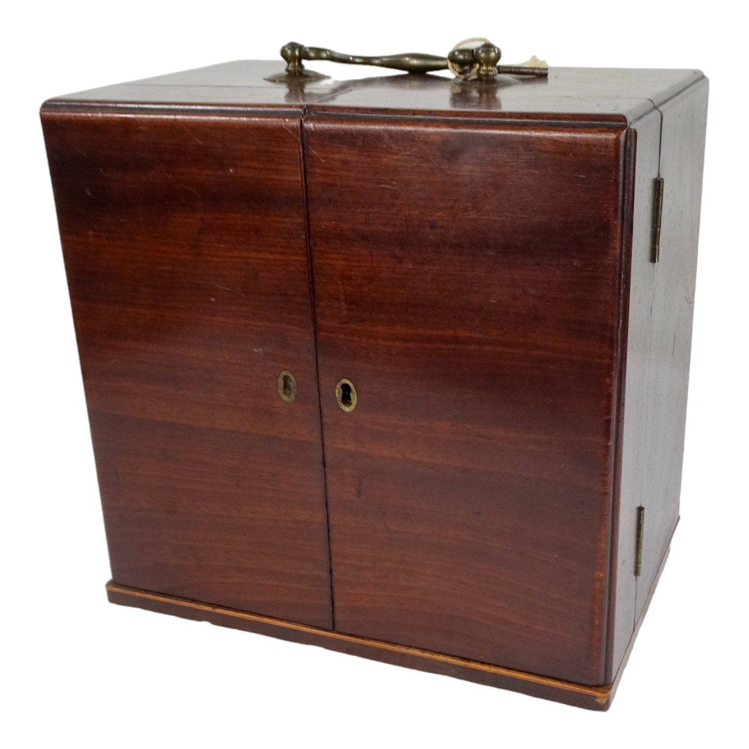 An early 19th century mahogany apothecary's chest - the top fitted with a bail handle, the double