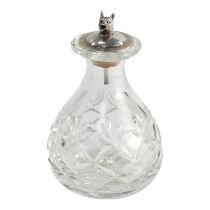 A silver topped scent bottle - the stopper modelled as a fox head, fitted to a cut glass bottle,