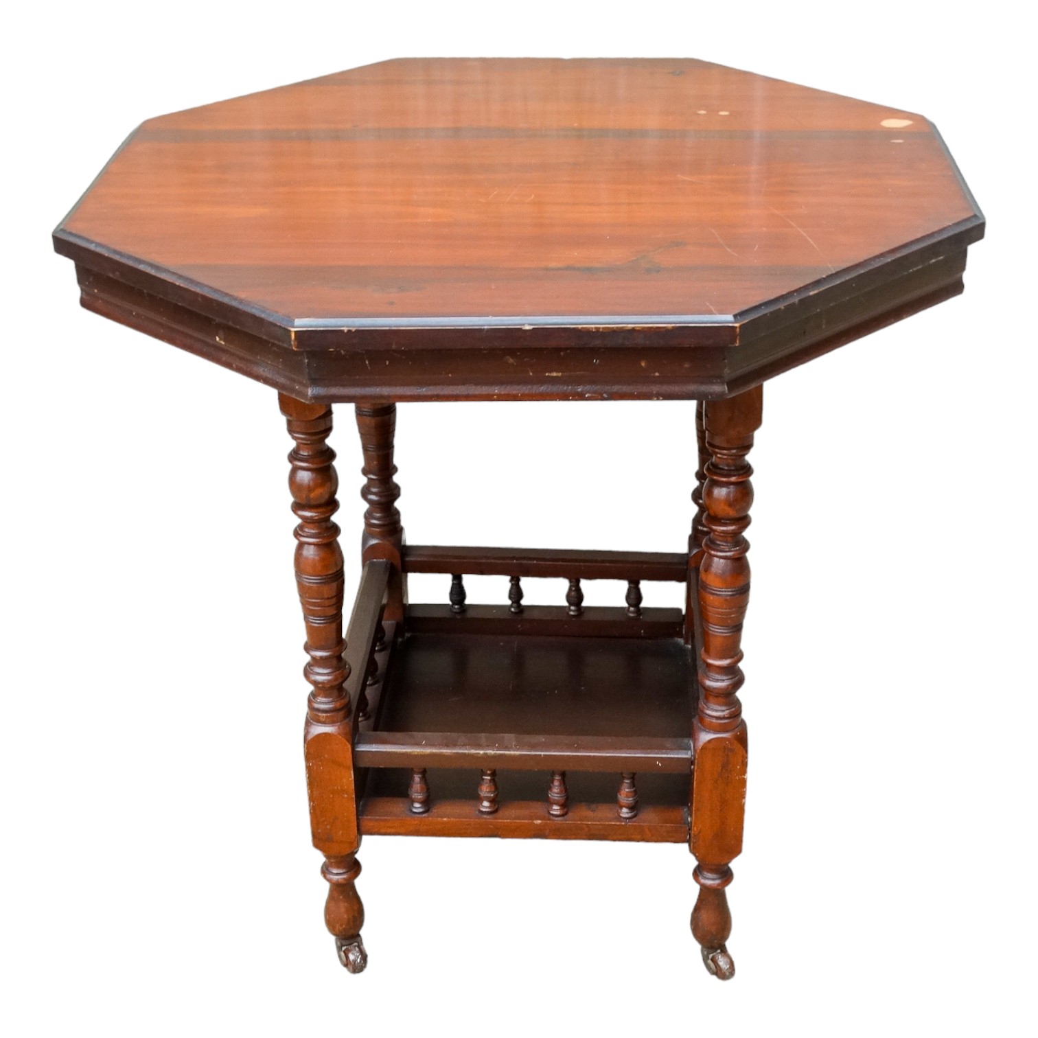 An Edwardian walnut octagonal centre table - the turned legs joined by a galleried undertier, 74cm x