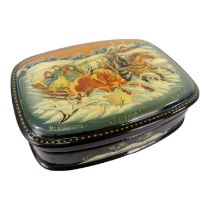 A Russian papier mache box - rounded rectangular form and decorated with a troika, 10cm wide