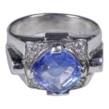 A platinum cornflower sapphire and diamond set ring - the large circular faceted central stone on