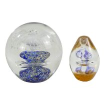 A late 20th century glass paperweight - with a dramatic floral centre, diameter 11cm, together