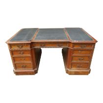 A George III stye mahogany partners desk - the leather inset top incorporating an inverted break