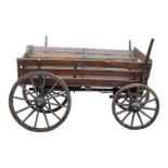 A late 19th century wooden wagon - the wooden wheels with iron rims and hubs, together with