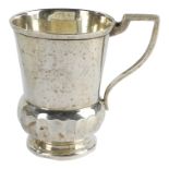 A silver christening mug - Sheffield, marks indistinct, thistle shaped and raised on a circular