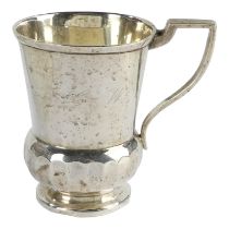 A silver christening mug - Sheffield, marks indistinct, thistle shaped and raised on a circular