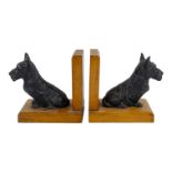 A pair of mid 20th century oak bookends - modelled with cast metal Scotty dogs, height 13cm.