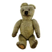 An early 20th century teddy bear - gold plush with articulated limbs, pad paws, stitched features