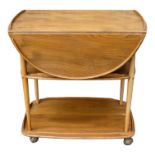 A vintage Ercol elm and beech serving trolley- the drop-leaf top with a gallery above two