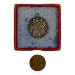 A George VI coronation token - together with a silver George V and Mary token.