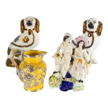 A 19th century Staffordshire figure group - one holding a watering can, the other a basket of
