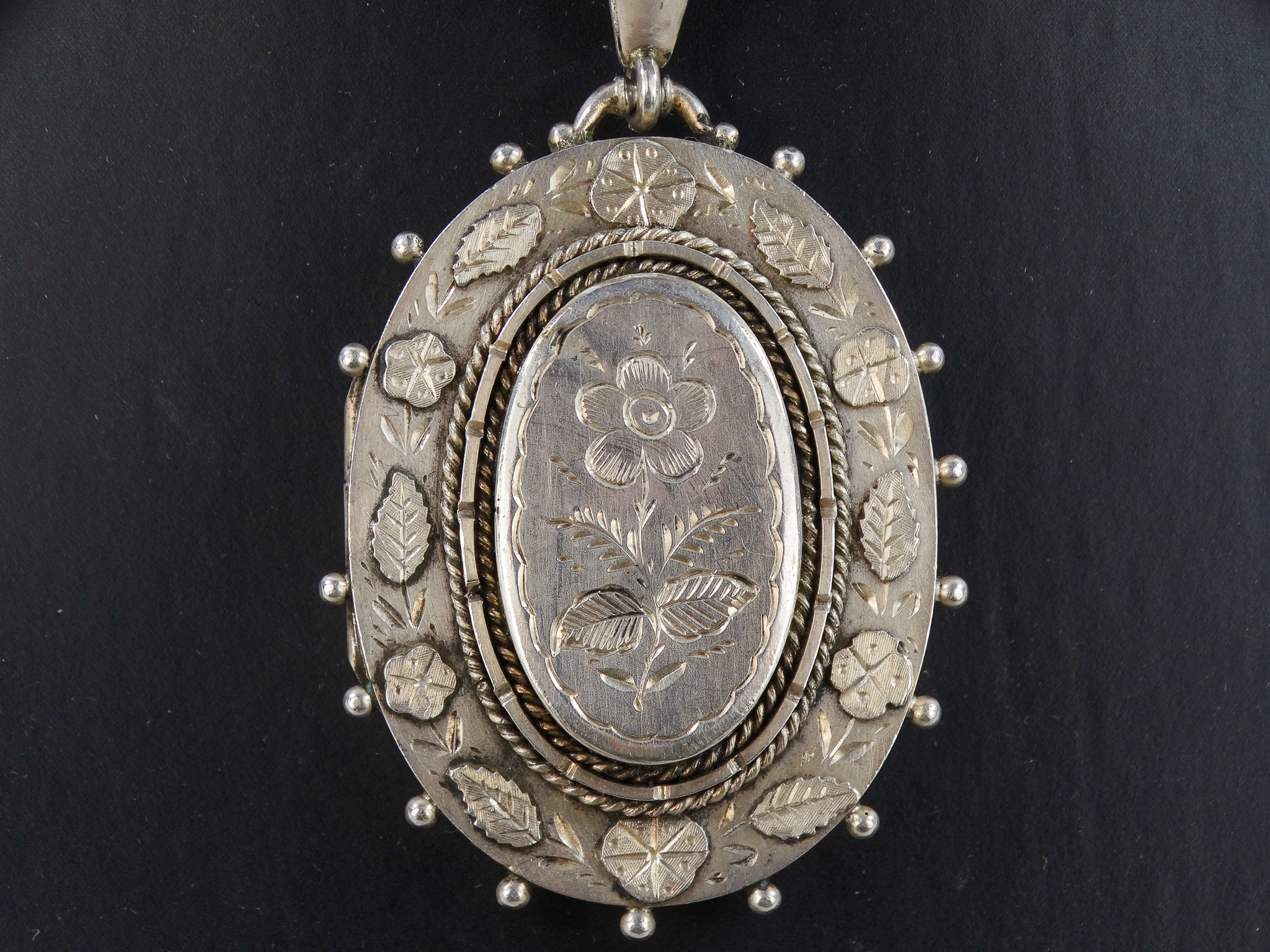 An oval silver locket - engraved with foliate decoration, on a broad fancy link chain with foliate - Image 4 of 6