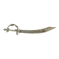 A middle eastern white metal miniature scimitar - with strike mark to blade, length 13.5cm, weight