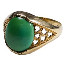 A 9ct gold ring - set with a green cabochon cut stone with pierced shoulders, size S, weight 3.2g.