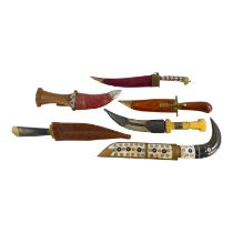 Six middle eastern daggers - with various hardwood and bone settings. (6)