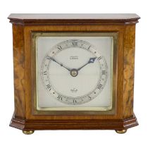 An Elliott mantel clock - silvered dial and chapter ring within a walnut case, height 14cm.