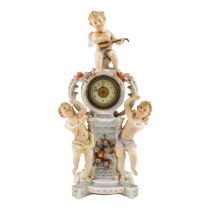 An early 20th century German porcelain mantel clock - modelled with three cherubs about a central