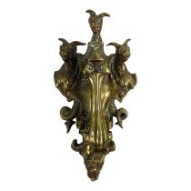 A late 19th century brass door knocker - cast with dragons, foliate scrolls and a green man mask,