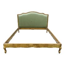 A Louis XVI style upholstered bed head - covered in sage green fabric within a gilt frame, with gilt