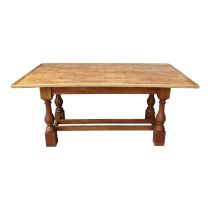 An oak 'parquet' top dining table- the rectangular top above a base with square and turned