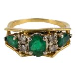 An 18ct yellow gold emerald and diamond five stone ring - size M/N, weight 4.2g.