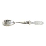 A silver serving spoon - London 1897, John Grinsell & Sons, with scallop shell bowl and cut glass