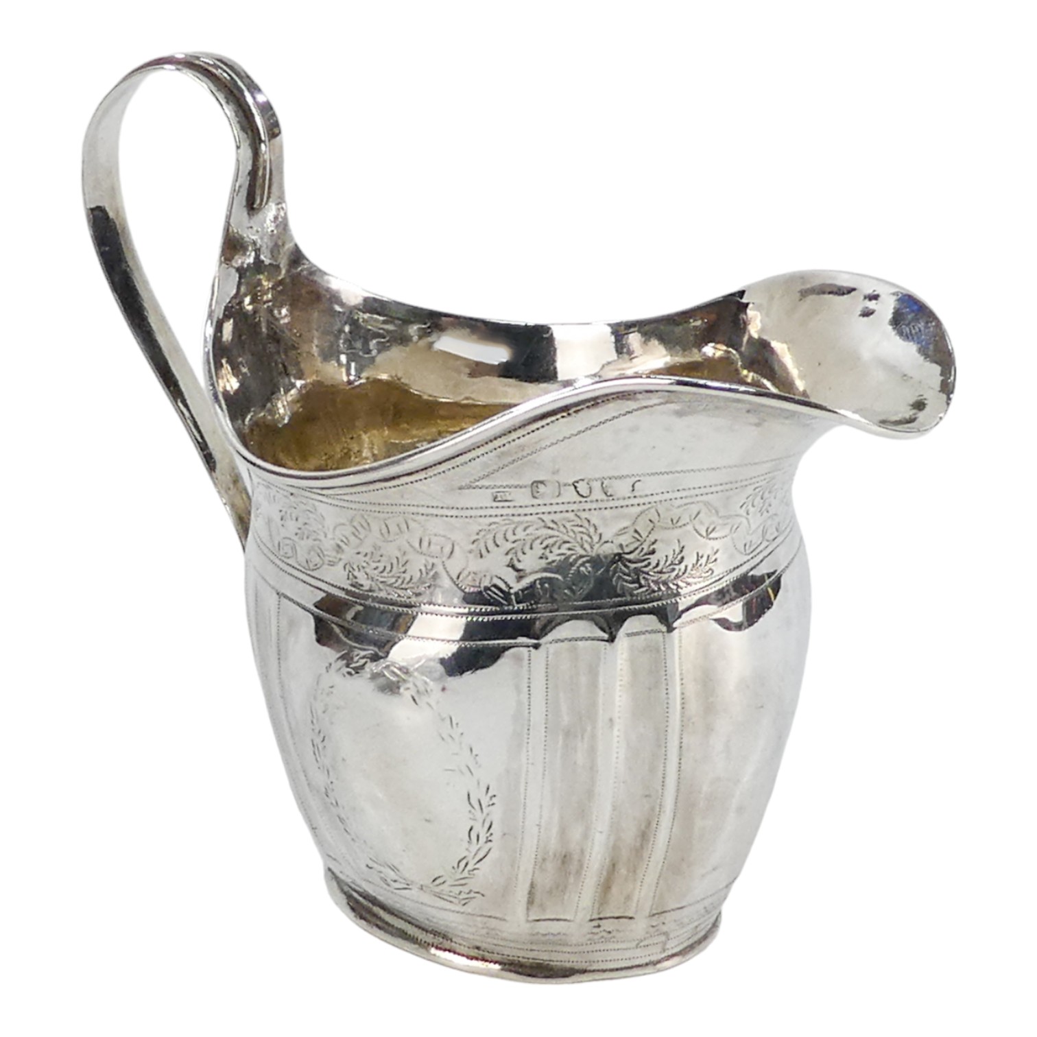 A Georgian silver cream jug - Newcastle, marks indistinct, fluted with engraved foliate bands,