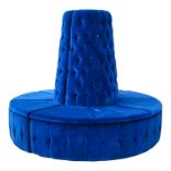A contemporary vivid blue velvet button upholstered circular bench - with a central tapering back