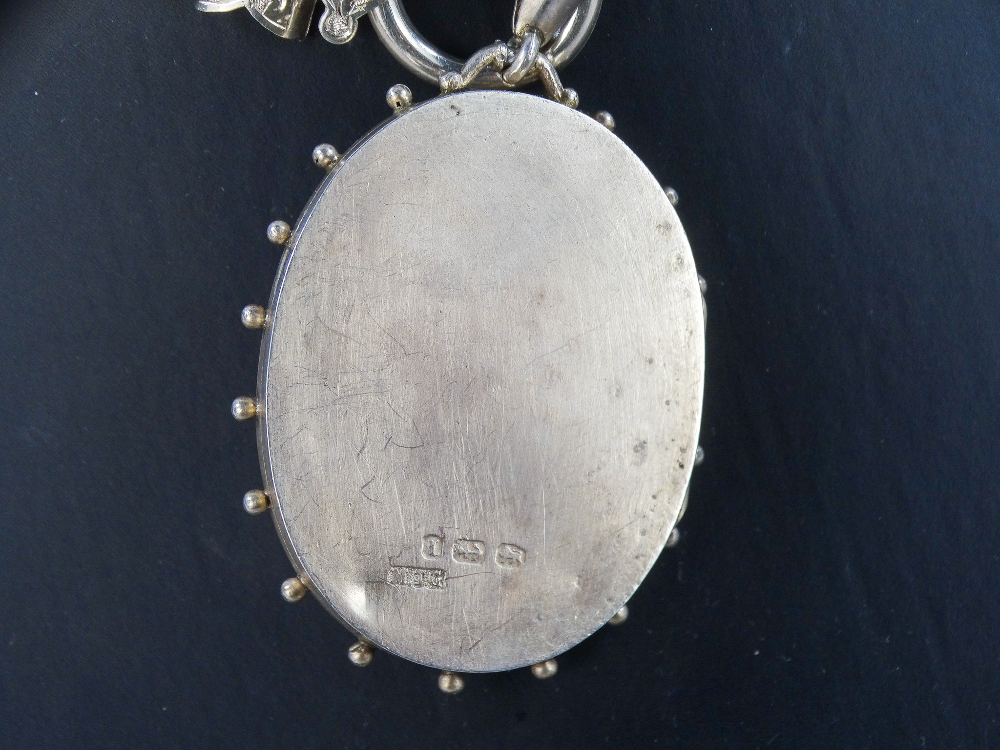 An oval silver locket - engraved with foliate decoration, on a broad fancy link chain with foliate - Image 5 of 6