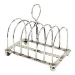 A silver toast rack - London 1897, William Hutton & Sons Ltd, with six divisions, raised on ball