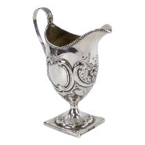 A Georgian helmet shaped cream jug - with repousse foliate decoration and raised on a square base,