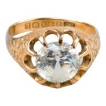 A 9ct gold ring - claw set with a white stone, the shoulders engraved with foliage, size Q, weight