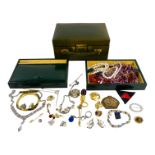 A quantity of costume jewellery in a green leather jewellery box.