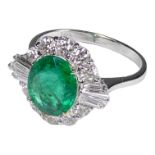 An 18ct white gold oval emerald and diamond cluster ring - emerald weight 1.89ct, diamond weight 0.