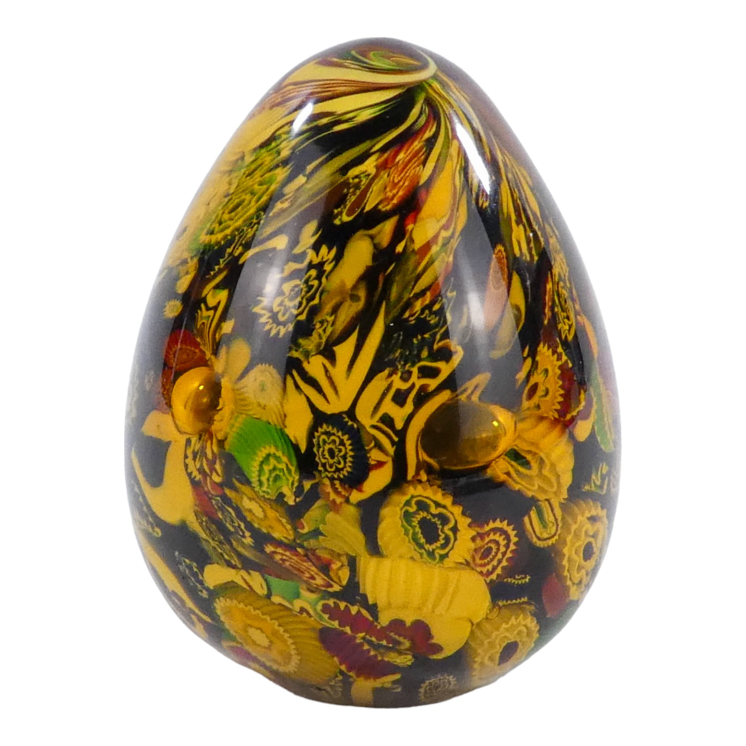 A Murano glass oviform paperweight - a collection of decorative canes with amber glass, height