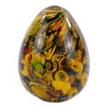 A Murano glass oviform paperweight - a collection of decorative canes with amber glass, height