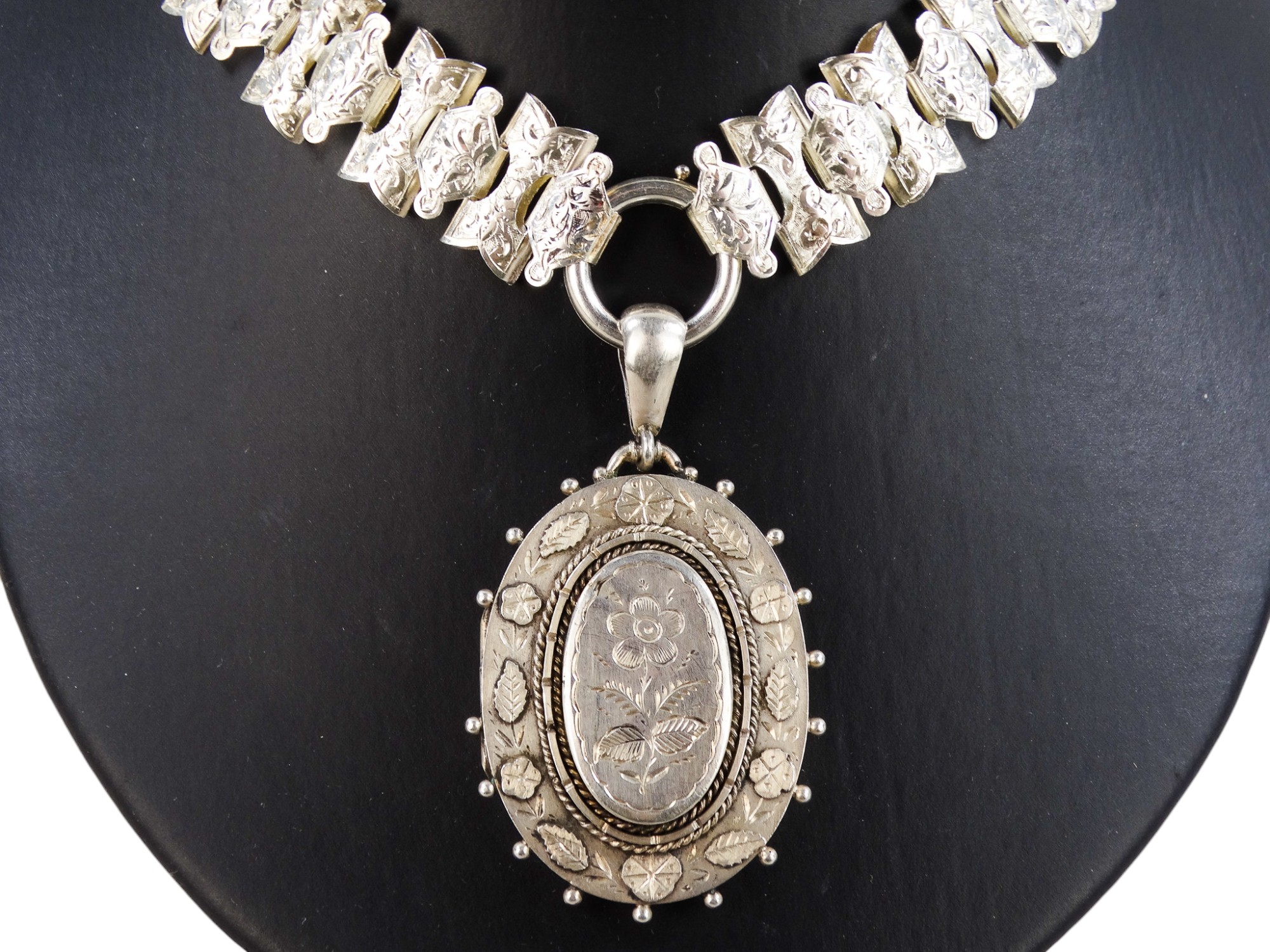 An oval silver locket - engraved with foliate decoration, on a broad fancy link chain with foliate - Image 2 of 6