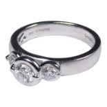 A 14ct white gold three stone diamond ring - with a collet setting, size M, weight 5.2g.