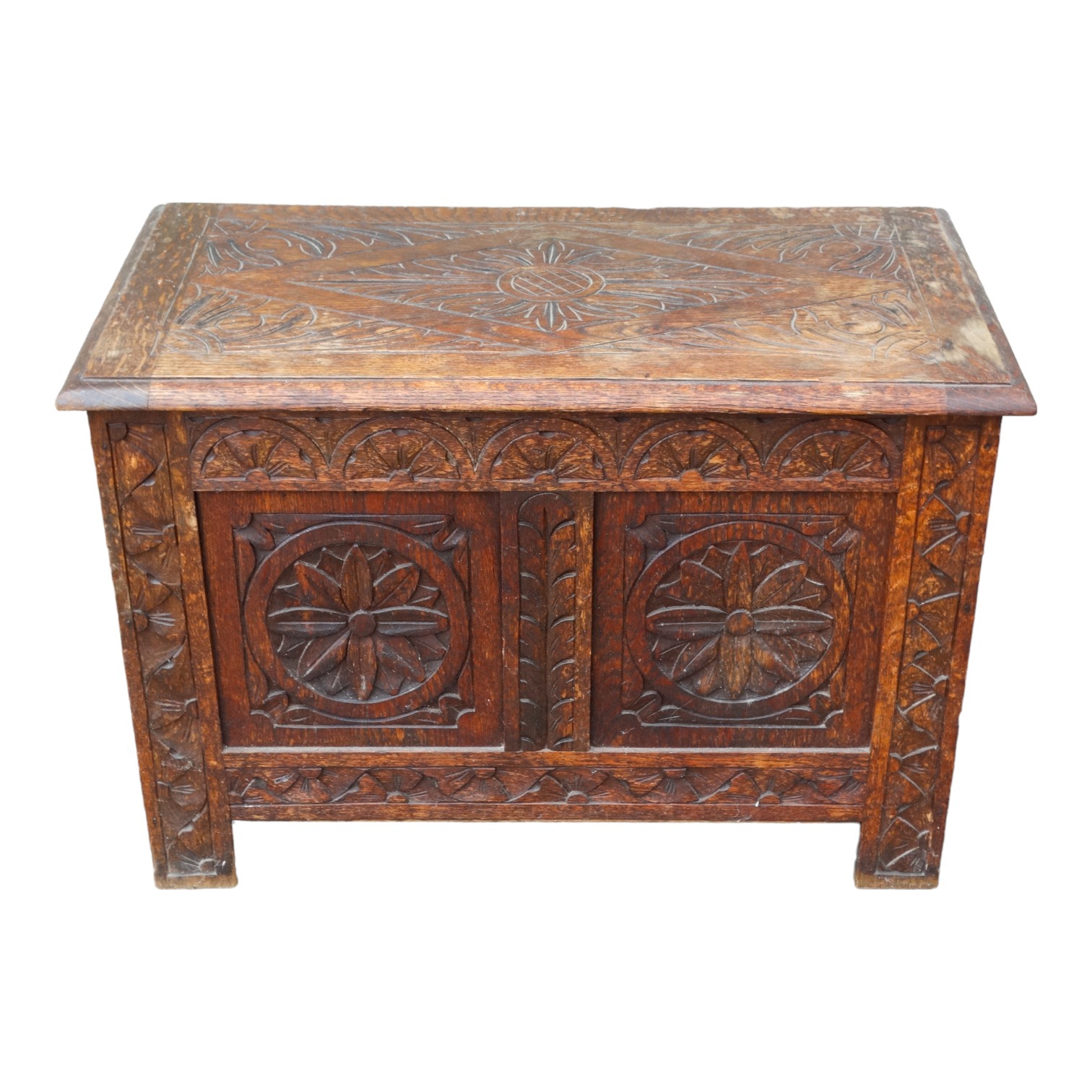 A 17th century style oak coffer - decorated with leaf carved panels, 75cm x 42cm x 51cm