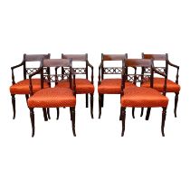 A set of six late George III style mahogany open armchairs - with pierced rail backs and overstuffed