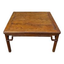 A late 19th century Chinese oriental hardwood low table - the square panelled top above cluster