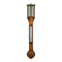 An early 20th century oak stick barometer - with a pair of vernier scales and incorporating a