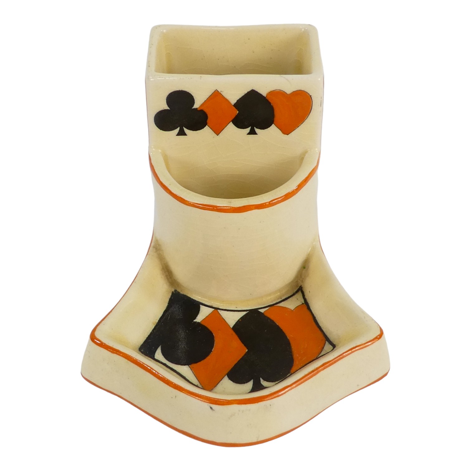 A Royal Doulton match striker - decorated with playing card symbols on a cream ground, height 7cm.