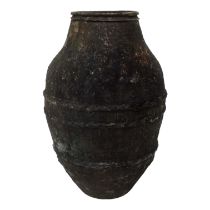 A terracotta olive oil storage jar - of ribbed barrel form, 63cm high