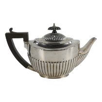 A silver teapot - London 1896, marks indistinct, of oval form with a part gadrooned body and with