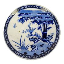 An early 20th century Chinese blue and white charger - decorated with a bird and landscape scene,