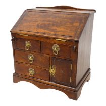 A late 19th century Continental walnut miniature bureau - the fall enclosing a fitted interior above
