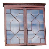 A 19th century mahogany bookcase - formerly part of a larger piece, the dentil cornice above a