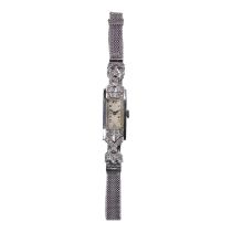An Art Deco platinum and diamond set cocktail watch - the rectangular white dial set out with